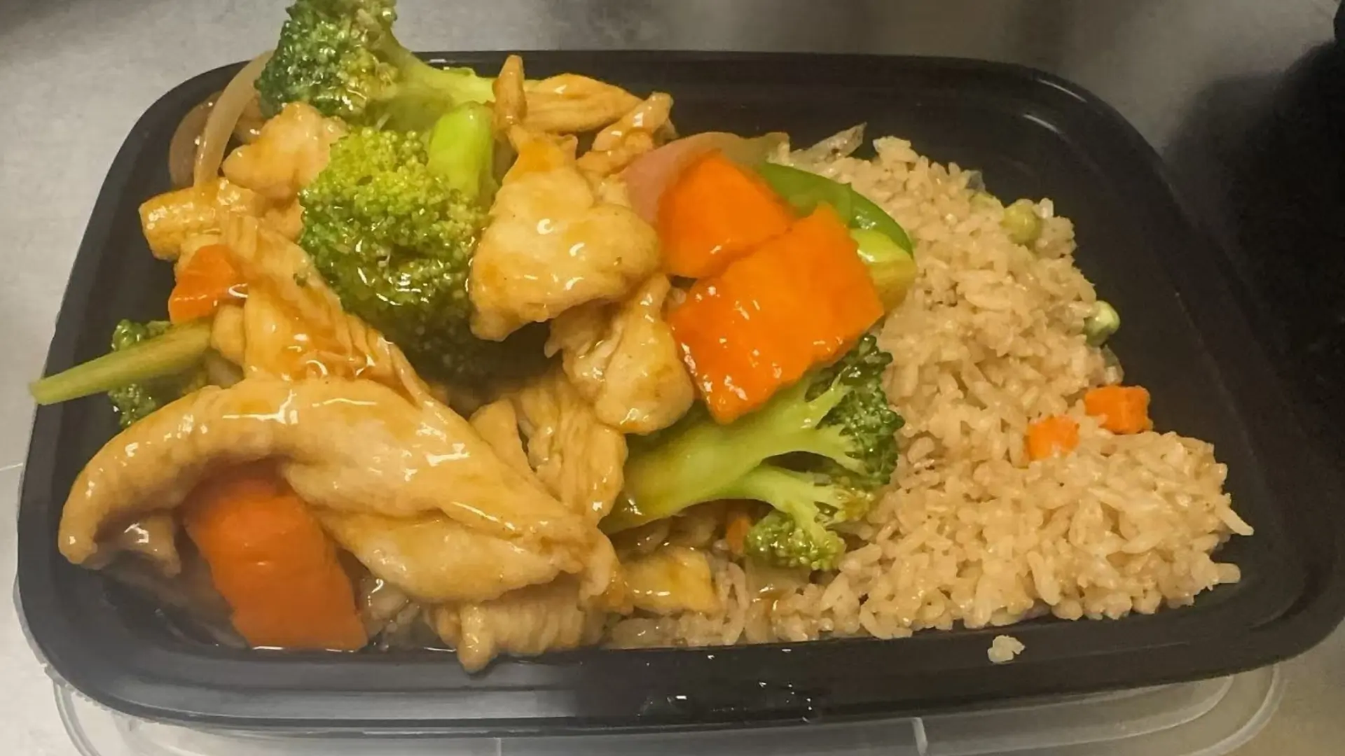 Chicken stir-fried with veggies and rice, a Chinese Restaurant in Rochester.